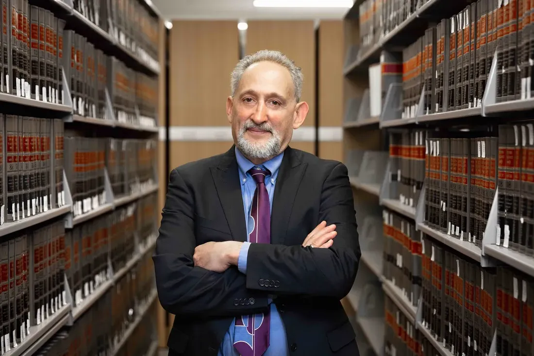 Professor David Driesen standing in the library.